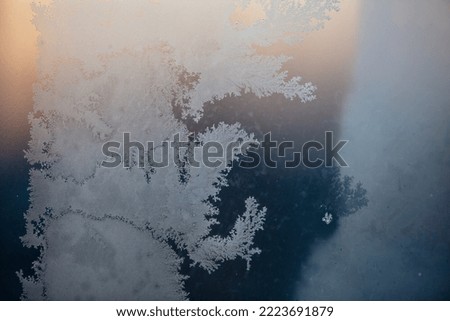 Frozen water on glass at sunrise. Close-up .