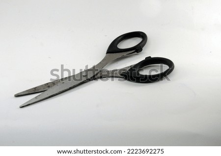 black scissors made from metal and plastic. it for peper cutter