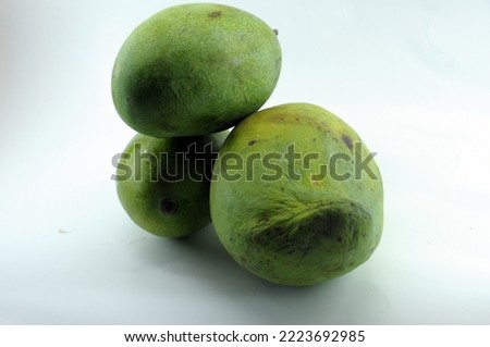 three manggos, tropical green fruit. 