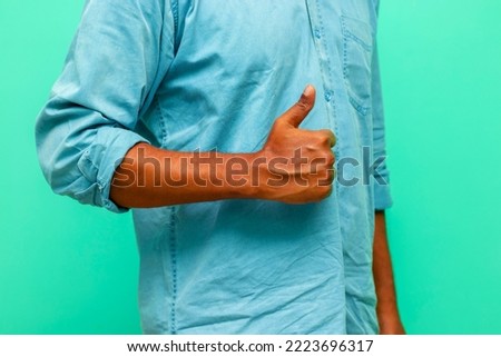Indian brown skin guy showing thumbs. 