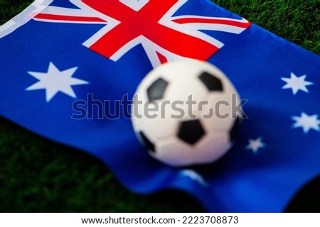 Australia national football team. National Flag on green grass and soccer ball. Football wallpaper for Championship and Tournament in 2022. World international match.