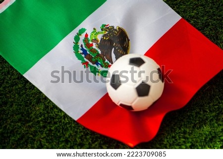 Mexico national football team. National Flag on green grass and soccer ball. Football wallpaper for Championship and Tournament in 2022. World international match.