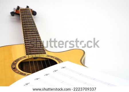 Acoustic guitar with music notes against white background. Love and music concept.