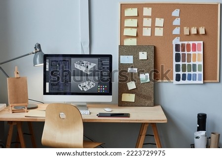 Background image of computer with 3D house model on screen at home office workplace, copy space