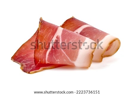 Spanish jamon iberico, serrano ham, isolated on white background. High resolution image Royalty-Free Stock Photo #2223736151