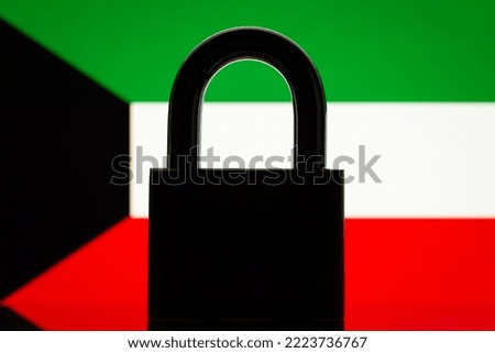 Lock against flag of Kuwait. Conceptual photo of big closed lock and flag of Kuwait, closed country concept, embargo, sanctions