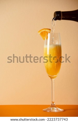 mimosa cocktail on yellow background Royalty-Free Stock Photo #2223737743