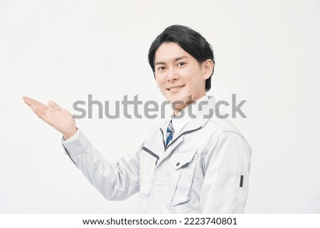 Asian worker pointing side  in white background