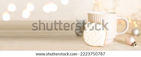 Cup of hot chocolate, Christmas cookie and decor on light background. Banner for design