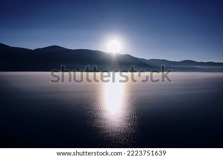 Sunrise over the mountain with reflection on the lake