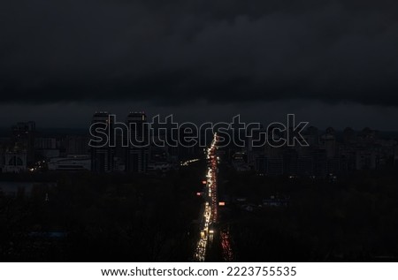 Blackout in the Ukrainian capital Kyiv. Capital streets without street lighting. Only the lights of passing cars are visible. Royalty-Free Stock Photo #2223755535