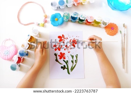 Child making homemade greeting card. little girl creating card for mom gift for Mothers day, Birthday or Valentines day . Arts  crafts concept. Royalty-Free Stock Photo #2223763787