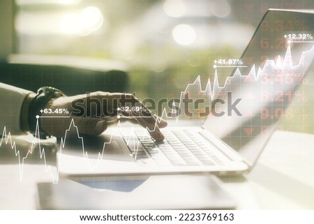 Multi exposure of abstract financial diagram with hand typing on computer keyboard on background, banking and accounting concept