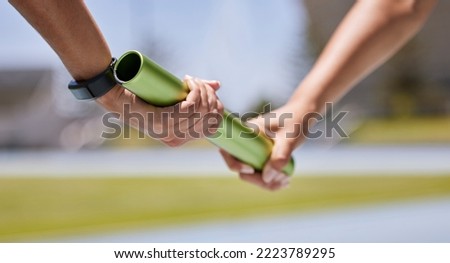 Sports, running and hands of runner with baton for exercise, fitness and speed at stadium. Sport, hand and team relay race challenge at running track by people marathon training, workout and energy Royalty-Free Stock Photo #2223789295