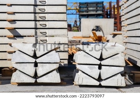 Elements of reinforced concrete stairs, a stack of steps in the warehouse of the precast concrete plant Royalty-Free Stock Photo #2223793097