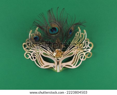 golden masquerade mask isolated on green background