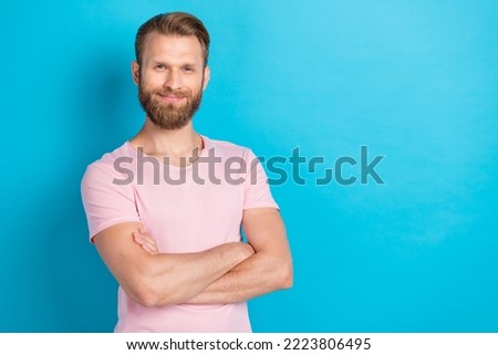 Photo portrait of attractive young man smiling shopping promo crossed arms wear trendy pink garment isolated on cyan color background