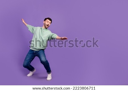 Full body size photo of youngster man student carefree get balance dance funny excited look empty space abyss dangerous isolated on violet color background Royalty-Free Stock Photo #2223806711