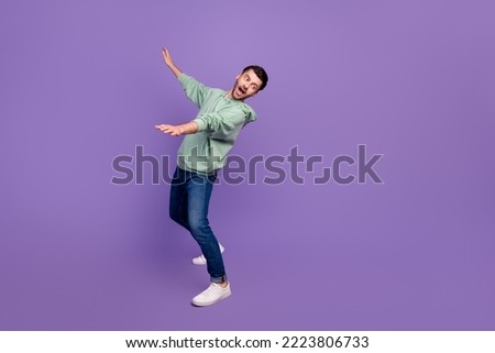 Full body length photo of young nervous funny man excited falling down no balance dangerous look empty space shocked isolated on violet color background Royalty-Free Stock Photo #2223806733