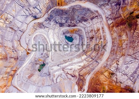 Top view of an open pit for the extraction of gold ore with depth of 250 meters Royalty-Free Stock Photo #2223809177