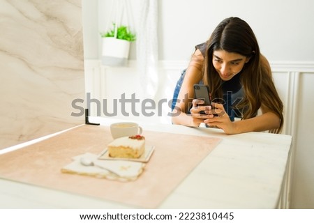 Female photographer or influencer doing a food photo shoot with a smartphone at the studio