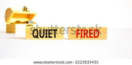 Quiet fired symbol. Concept words Quiet fired on wooden blocks. Beautiful white table white background. Wooden chest with coins. Business and quiet fired concept. Copy space.