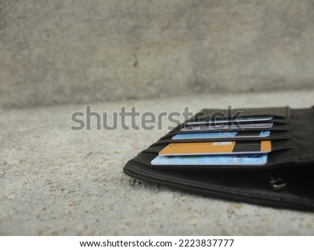 atm card, credit card in brown leather wallet on gray background