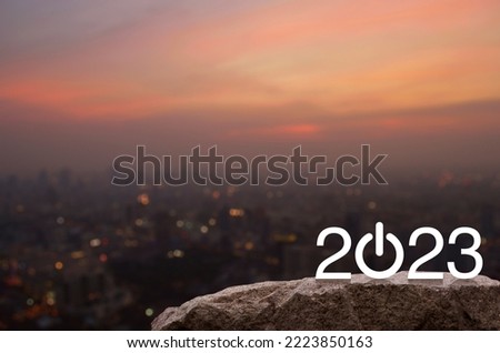 2023 start up business flat icon on rock mountain over cityscape on warm light sundown, Happy new year 2023 cover concept