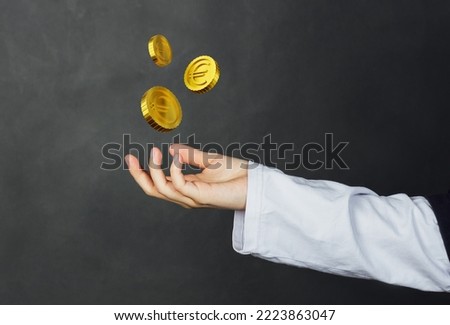 The hand palm almost touch stylized gold euro coins in the air. High quality 3d render illustration and photo