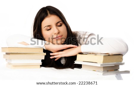 beautiful brunette student tired of doing homework sleeps on the table with books