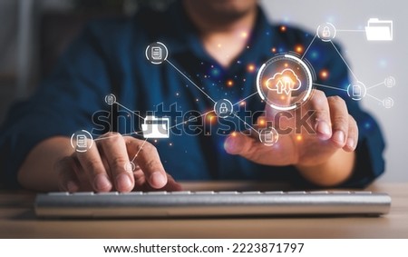 Businessman working on virtual screen of Document Management System (DMS). Software for archiving, searching, and managing corporate files and information, documentation in enterprise with ERP. Royalty-Free Stock Photo #2223871797