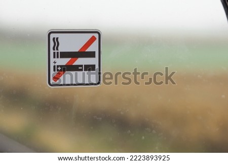 Sign no smoking cigarette and e-cigarette in public place. Stop smoking and vaping sign on the train window background.