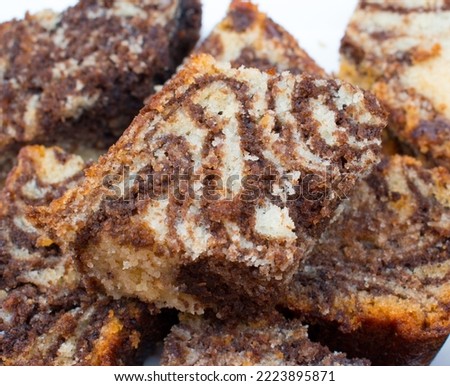 Zoom image of Healthy and Homemade freshly baked Marble fruit cake in white plate for Christmas or other important occation. Macro photo.
