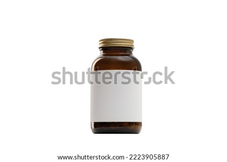 Glass jar with pills, medicine or vitamins on the table. Light background. Isolated white background.