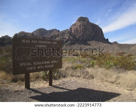 Bear And Mountain Lion Country Warning Sign At National Park Entrance - Desert and Mountains Landscape Background, Big Bend National Park Texas