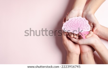 hands holding human brain shape paper cut, idea creative intelligence thinking or Awareness of Alzheimer, Parkinson's disease, dementia, stroke, seizure or mental health. Neurology and Psychology care Royalty-Free Stock Photo #2223916745