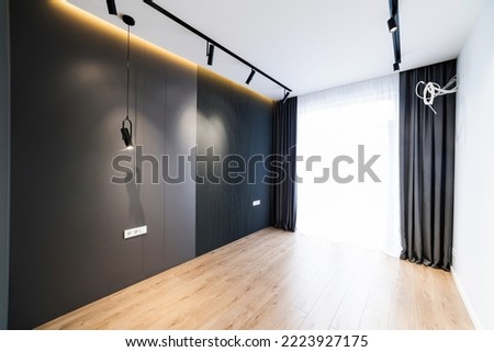 Empty room with black wall and window