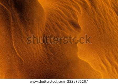 Close up orange sand texture in Empty Quarter Desert in United Arab Emirates. Sand dunes. Abstract sand texture. Royalty-Free Stock Photo #2223935287