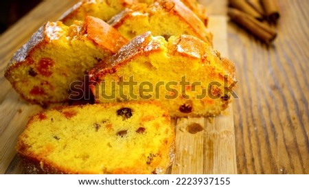 image of a delicious cupcake with raisins and candied fruit on a board close-up 