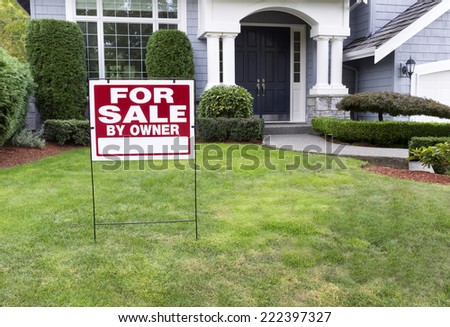 Closeup view of Modern Suburban Home for Sale Real Estate Sign in front of modern home