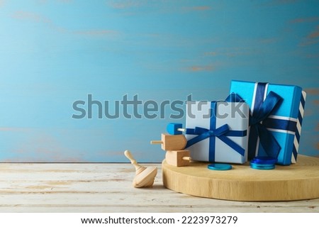 Gift boxes and spinning top  on wooden table. Hanukkah holiday background
