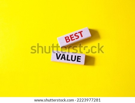 Best value symbol. Wooden blocks with words Best value. Beautiful yellow background. Business and Best value concept. Copy space.