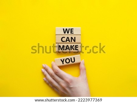 We can make you symbol. Concept words We can make you on wooden blocks. Beautiful yellow background. Businessman hand. Business and We can make you concept. Copy space.