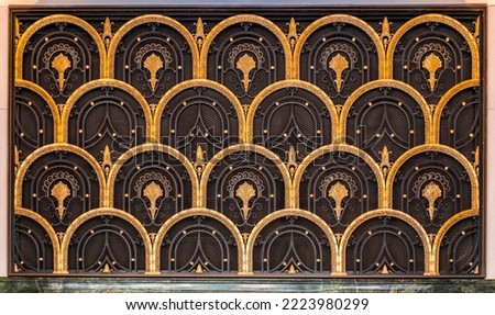Art deco style European door with gold colored fish scale ornaments, architectural detail from Madrid, Spain Royalty-Free Stock Photo #2223980299