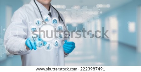 Doctor clicks medical icons on virtual computer screen.