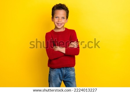 Photo portrait of charming little boy confident pose promo crossed arms wear trendy red knitwear outfit isolated on yellow color background
