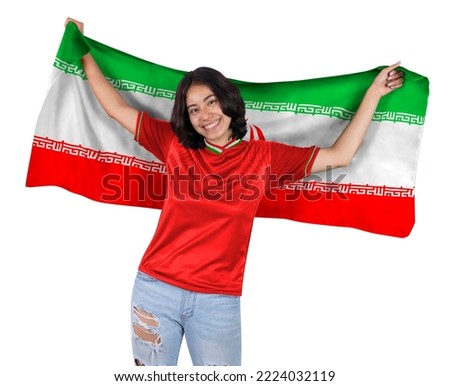 Young soccer fanatic woman with red sports jersey and flag to IR IRAN in his hands, happy for the victory of his favorite team. Royalty-Free Stock Photo #2224032119