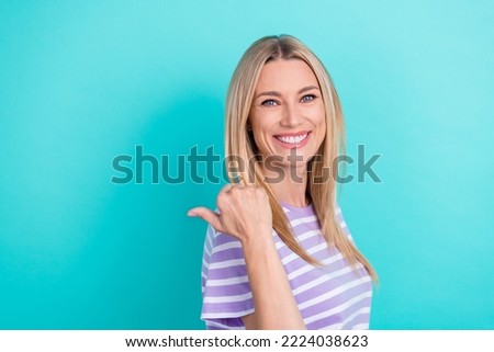 Profile photo of business lady wear striped purple t-shirt toothy beaming smile finger directing empty space ad isolated on cyan color background