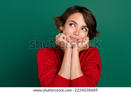Photo of nice brown hair young lady hands face look up wear red sweater isolated on green color background