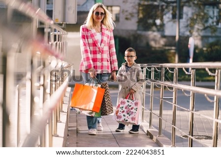 Mother and son shopping together in the shopping center. Family shopping